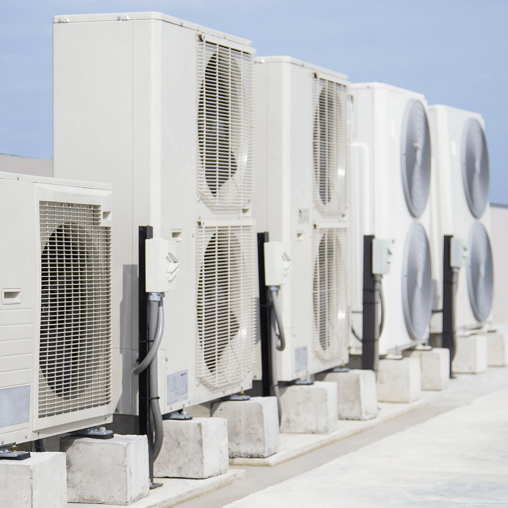 Anderson Plumbing Heat and Air technician inspecting air conditioning unit in a Norman, OK family home on a summer day
