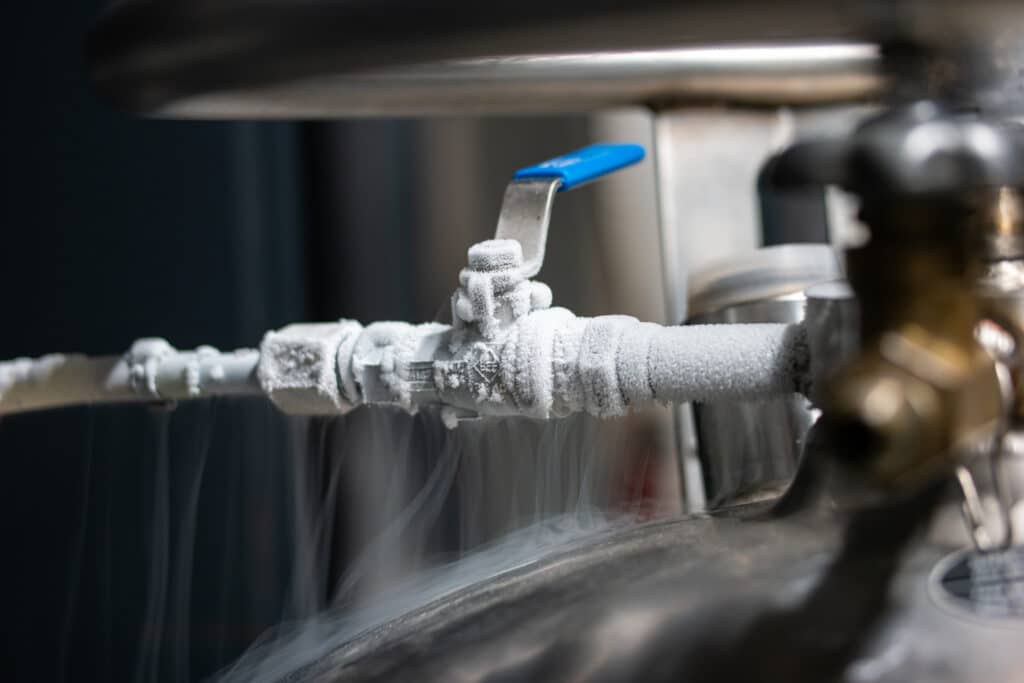 Skilled technician using diagnostic tools to assess plumbing in a Piedmont, OK restaurant’s kitchen