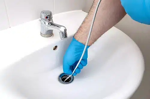 Licensed plumber inspecting pipes Anderson Plumbing Heat and Air