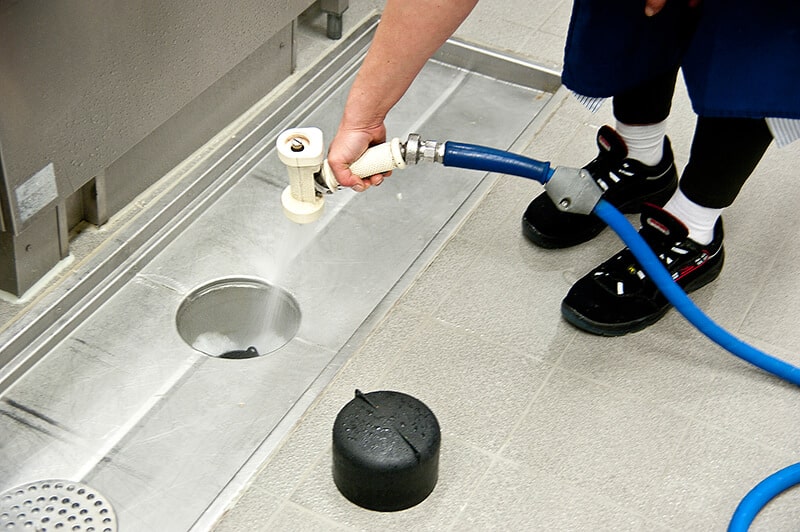 Licensed plumber verifying code compliance on commercial plumbing installation in Nichols Hills, OK business suite