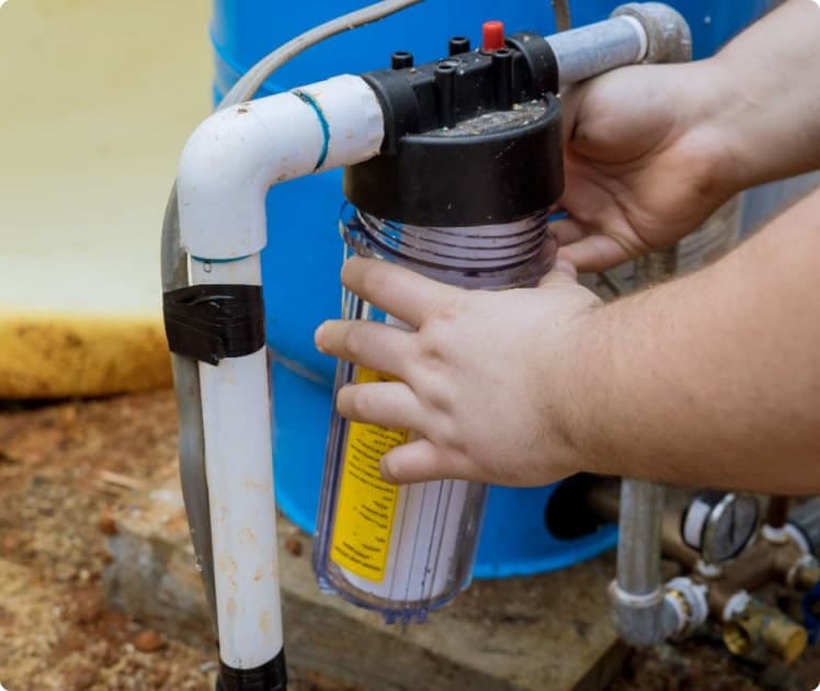 Installer adjusting a water softener system in a Piedmont, OK utility room with advanced tools