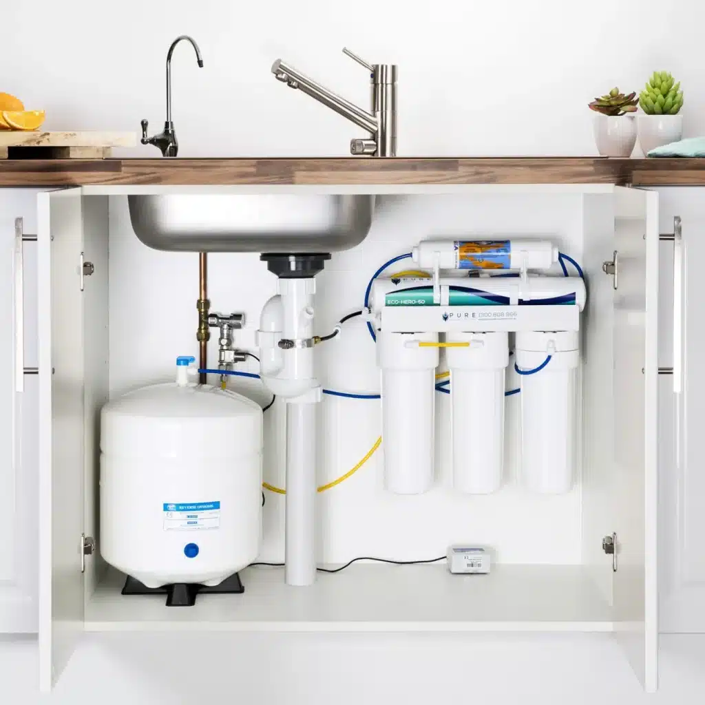Plumber repairing water line in upscale Nichols Hills office building with high-end finishes and fixtures