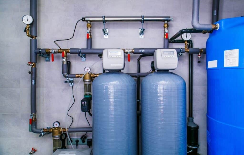 Skilled technician using diagnostic tools to assess plumbing in a Piedmont, OK restaurant’s kitchen