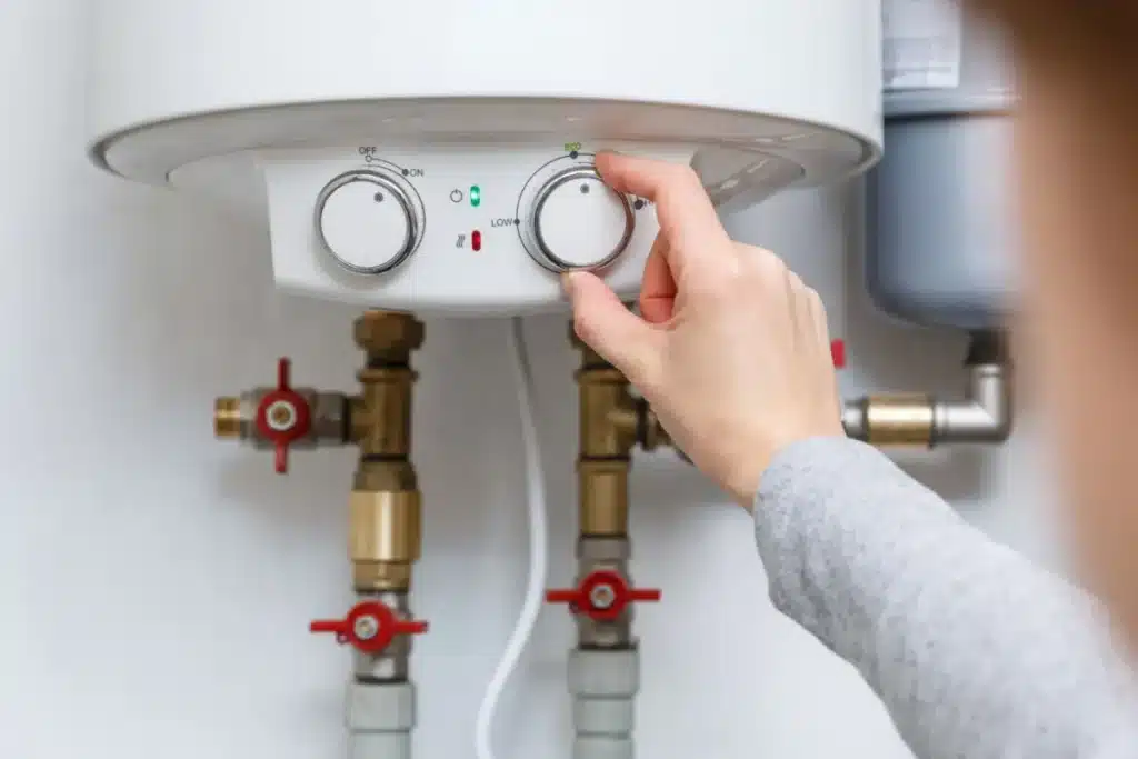 Plumber performing Water Heater Repair near a utility closet in a Piedmont, OK home