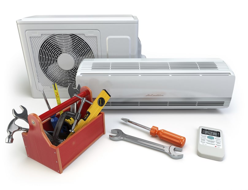 HVAC technician troubleshooting AC unit with digital gauges in Midwest City home during urgent summer service call