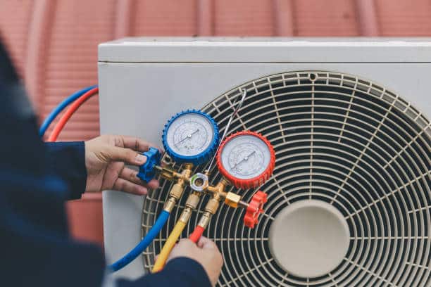 Expert technician performing diagnostic testing on high-efficiency AC system in Yukon, OK residential home