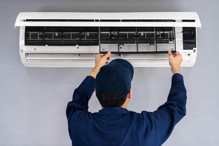 Skilled technician performing urgent AC repair in Edmond office to restore cooling for employees