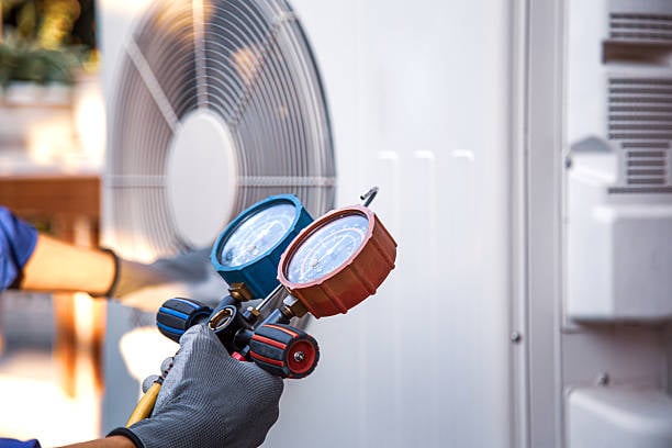 Technician performing HVAC repair diagnostics in an Oklahoma City, OK attic during a summer cooling failure