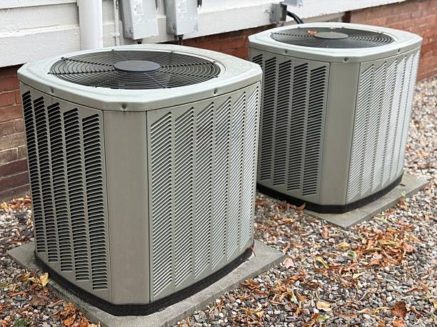 Specialist performing HVAC repair diagnostics in a Nichols Hills, OK attic near duct connections